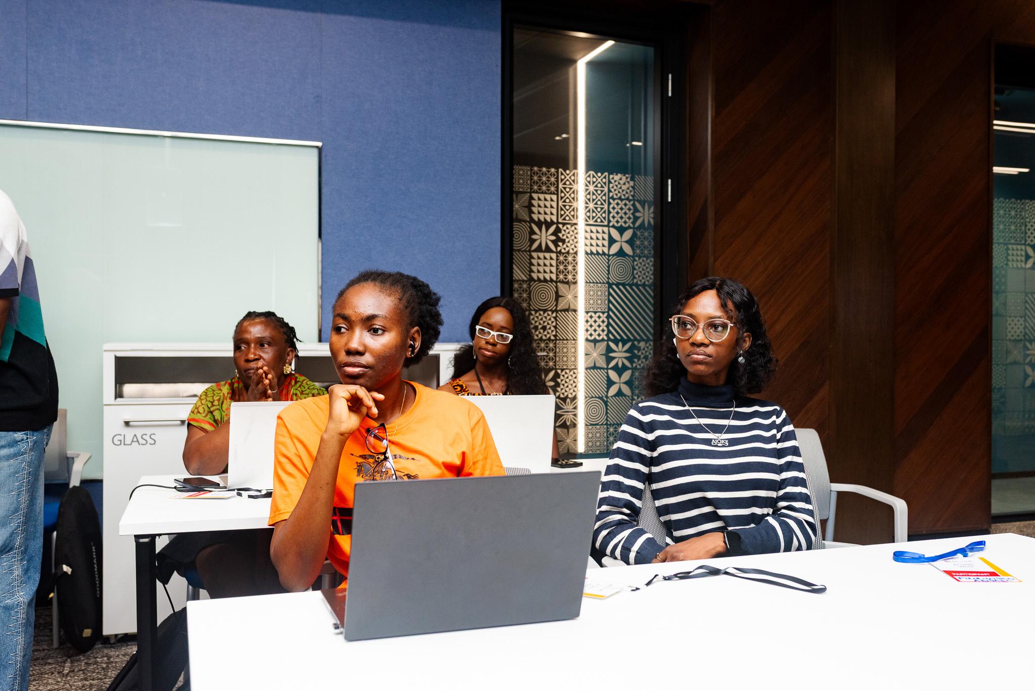 Four smiling young women from the TTS Nigeria training program